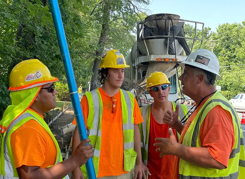 Papaneri and Sons crew in hard hats and safety vests beside a concrete mixer truck in Cherry Hill, New Jersey