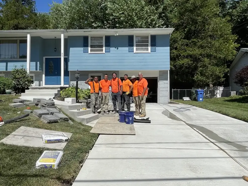 Papaneri & Sons concrete crew in orange shirts on a finished driveway, the team that serves Haddonfield, NJ