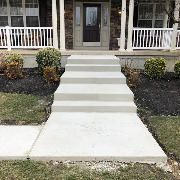 Wide finished concrete front steps leading up to a covered porch, the kind of entry work common on Haddonfield homes