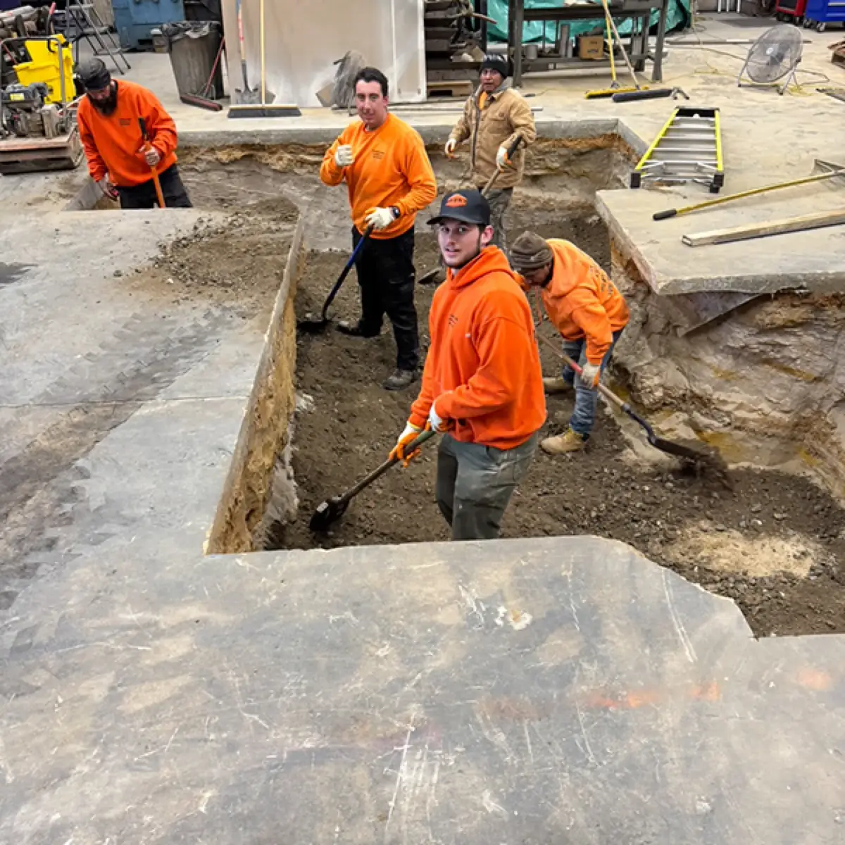 Papaneri crew hand digging below an existing concrete slab in Cherry Hill, NJ