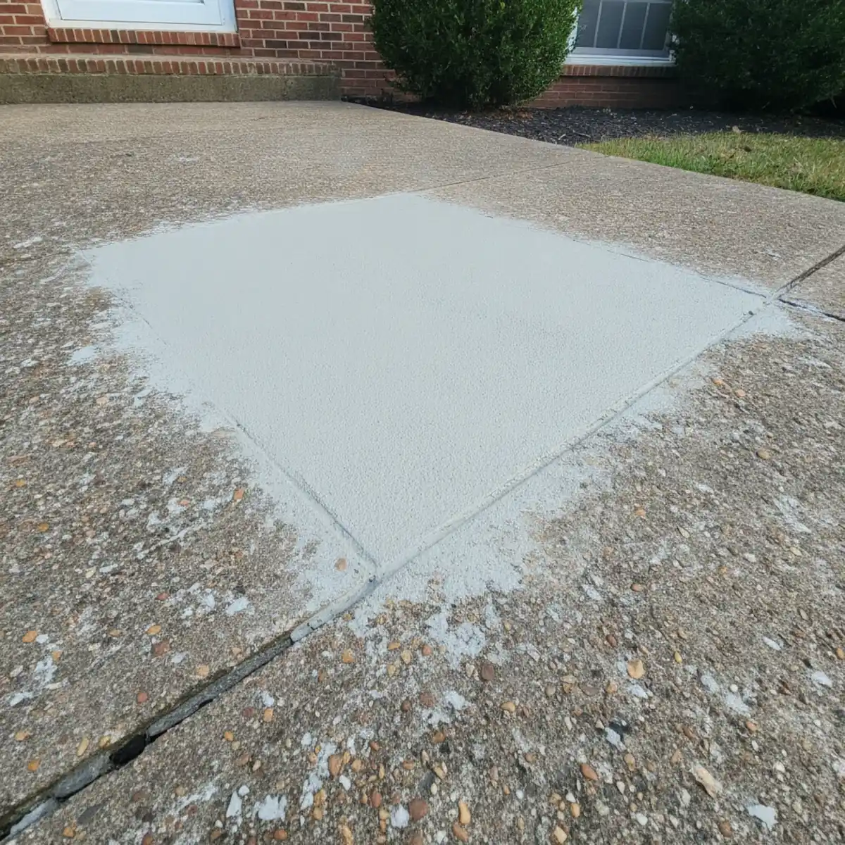 Patched spalled area on a concrete driveway in Cherry Hill, NJ