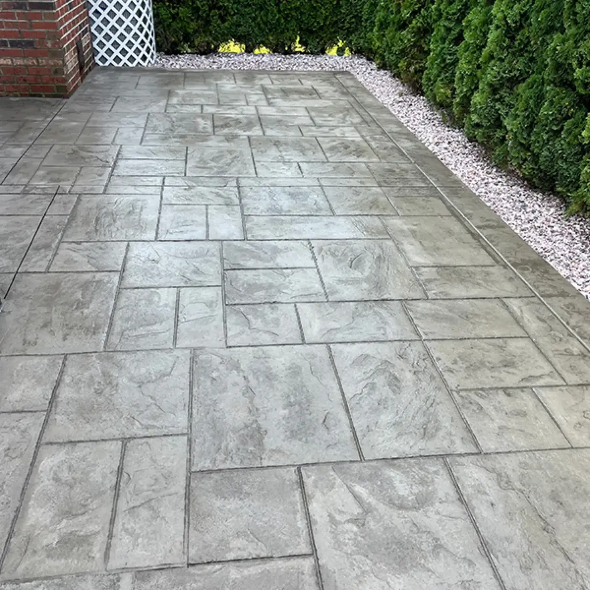 Close-up of a stamped concrete surface in a large-format ashlar slate pattern with mortar-line detail